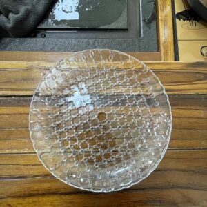 A clear pressed glass plate featuring intricate lace-like patterns across its surface. The round plate has a central hole, reflecting light and showcasing its smooth edges. Ideal for decorative purposes, this glassware highlights the fine details of pressed glass craftsmanship, making it a beautiful addition to any table setting.